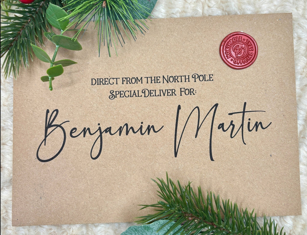 Flat lay of customised Santa letter and envelope on festive background